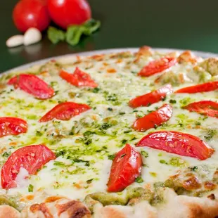 a pizza topped with tomatoes