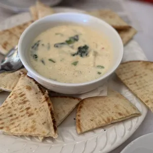 a bowl of soup and pita chips