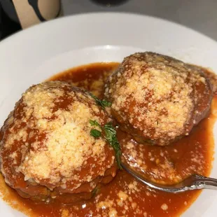 two stuffed mushrooms on a plate
