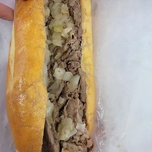 Cheesesteak with jalapeño cheese whiz only in the middle with onions (they ran out of sweet and spicy peppers)