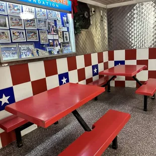 a red table and benches