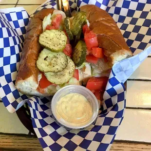 Turkey, melted provolone cheese, lettuce, tomatoes, and pickles with a horseradish sauce. The sandwich bread has a wonderful crunchy crust.