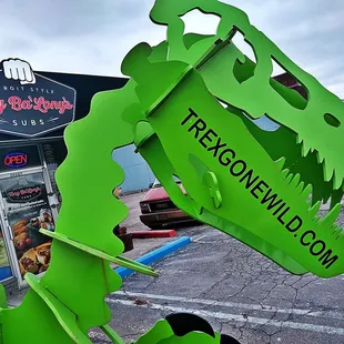 a green dinosaur sign