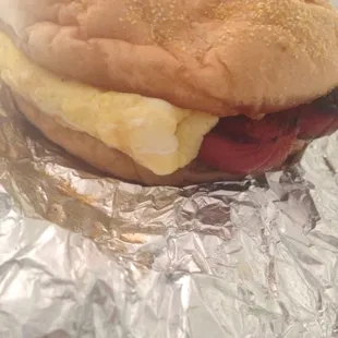 Hot sausage, egg, and cheese on a kaiser roll