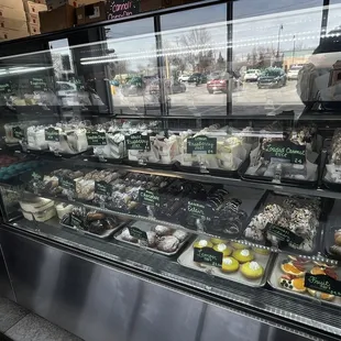  display case full of cakes and pastries