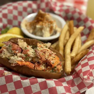 Lobster roll with potato salad and fries