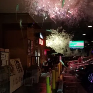 fireworks in the sky above a parking lot