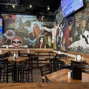 Lots of high-tops by the mural on the bar-side of the restaurant