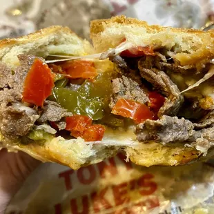Inside of Cheesesteak with provolone cheese and roasted peppers
