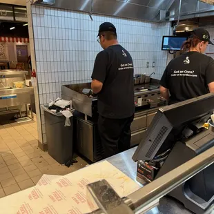 Putting the frozen slabs on the flat top and making cheesesteaks.