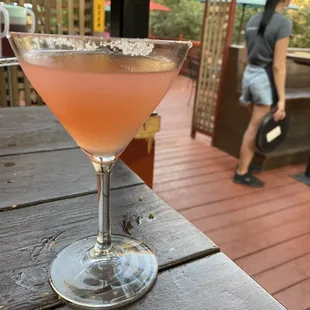 a pink drink in a coupe glass