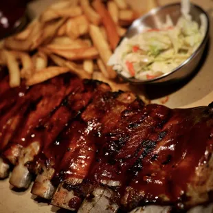 a plate of ribs and french fries