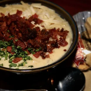 a bowl of soup with bacon and chives