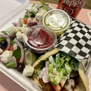 Falafel Sandwich with Greek salad and drink.