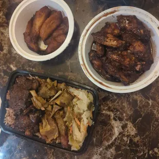 Plantain, oxtail and goat curry with rice, jerk wings