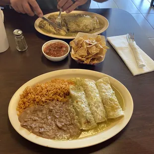 The smothered Chile Verde burrito and three enchilada plate with one shredded beef and two chicken.