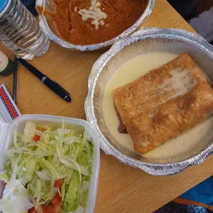 Chimichanga, beans  and salad mix.