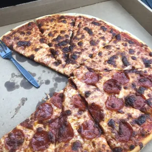 Burnt half cheese and half pepperoni pizza