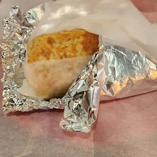 a burrito wrapped in aluminum foil