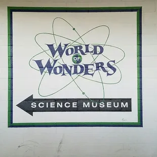 Logo and hand lettering on wall inside parking garage