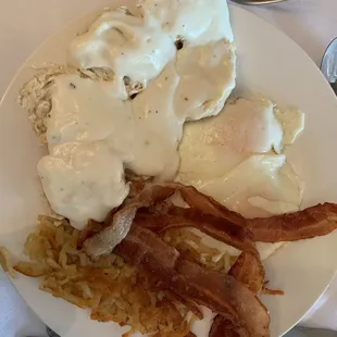 Bacon, hash browns, eggs over easy, biscuits and gravy
