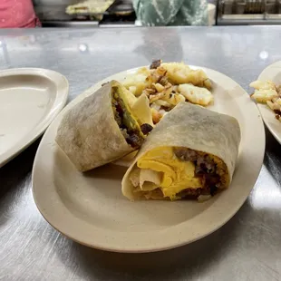 Breakfast Burrito Two Eggs scrambled, Onions, Green Peppers, your Choice of Meat, served with Homefries and Toast $10.99