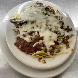 Baked spaghetti with homemade sauce (with green peppers, onions, and mozzarella cheese served with a side salad and garlic toast) $12.95
