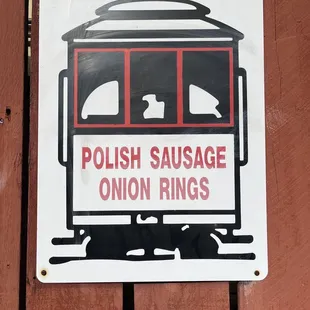 a sign on a wooden fence