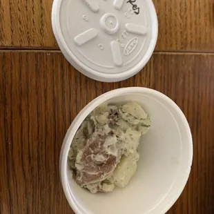 This tiny amount of red potato salad was in this tiny container.