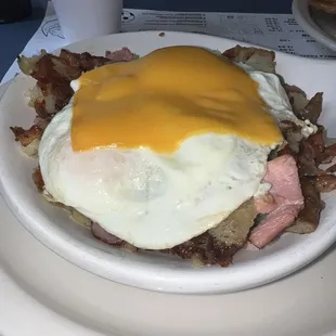 Skillet- bacon, sausage, ham, over medium eggs American cheese
