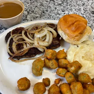 Hamburger steak with grilled onions and gravy on the side.  Mashed potatoes and fried okra and roll.  SO GOOD!