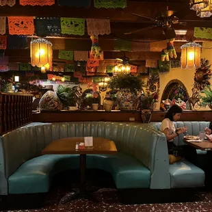 two people sitting at a table in a mexican restaurant