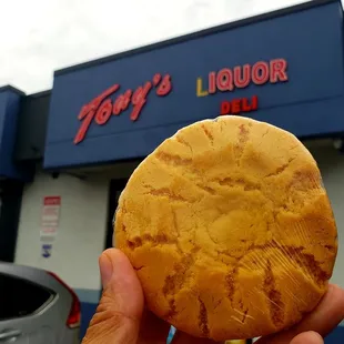 a hand holding a cookie