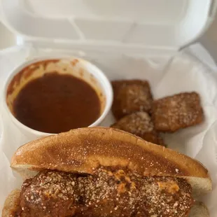 a meatball sandwich and dipping sauce