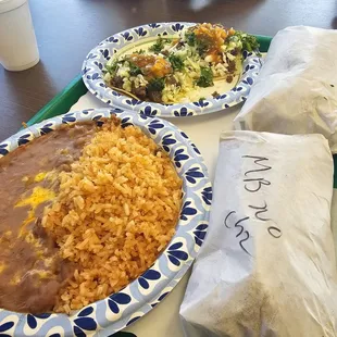 Rice and beans, chili Verde burrito, carne asada burrito and tacos.