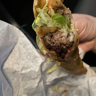 Ground beef taco with Black meat, no flavor, old overdone taco shell.