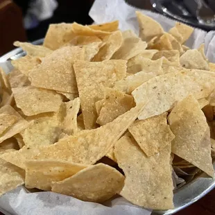 Crushed up chips. They came long after the queso was plopped on the table.