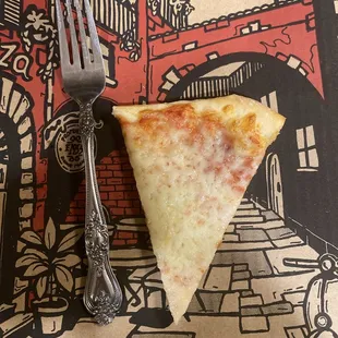 A puny little medium slice next to a standard dinner fork for comparison.