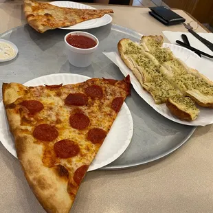 Huge slices. We got a slice of cheese, a slice of pepperoni, a side of garlic bread, and a Sprite.