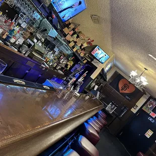 Left side of the bar.