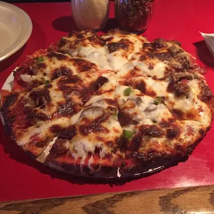a pizza on a red table
