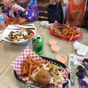two children sitting at a table eating