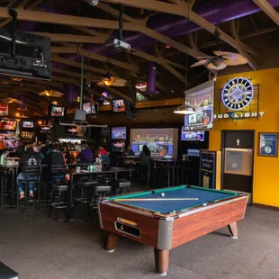 a pool table in the middle of the room