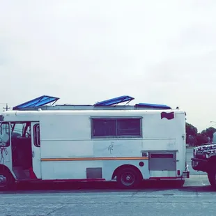 a taco truck with solar panels on the roof