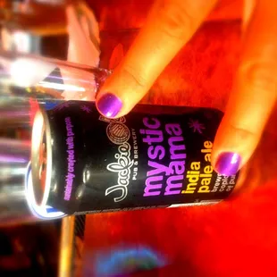 a hand holding a can of beer