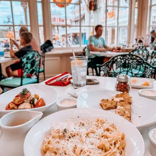 a table with pasta and other dishes