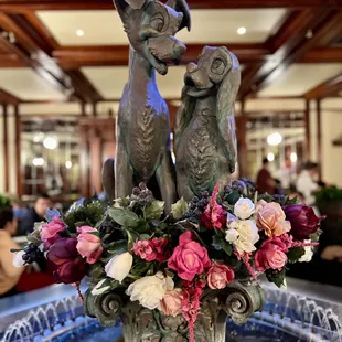 a fountain with flowers in it