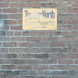 a sign on a brick wall