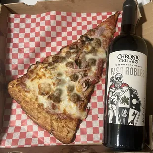 Don&apos;t sleep on these giant pizza slices.  Delicious, and she thicc too.  A whole meal right here.  Wine bottle added for scale.