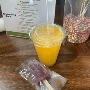 a cup of ice cream and a bag of sprinkles